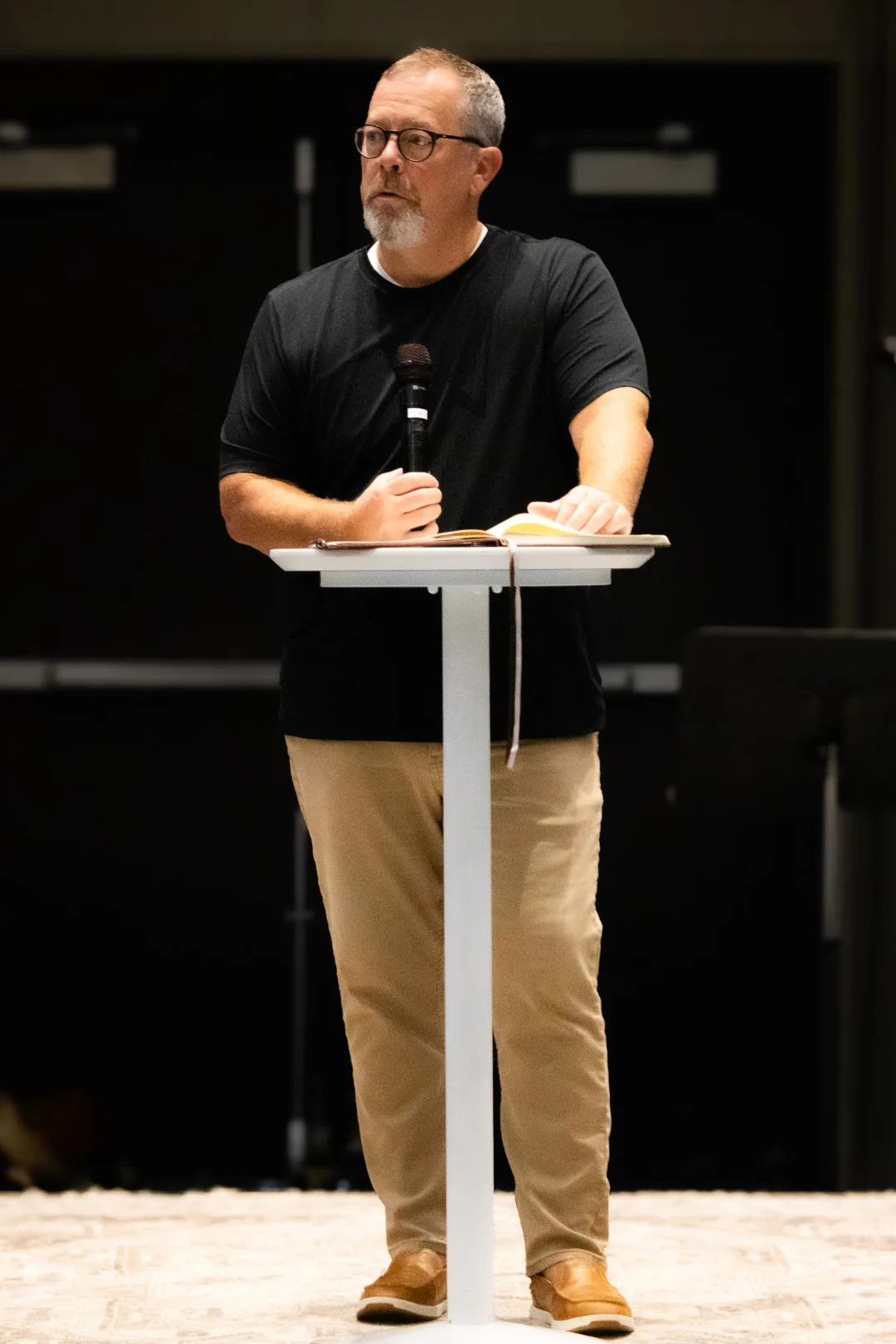 Chad Norris teaching from notes at a podium